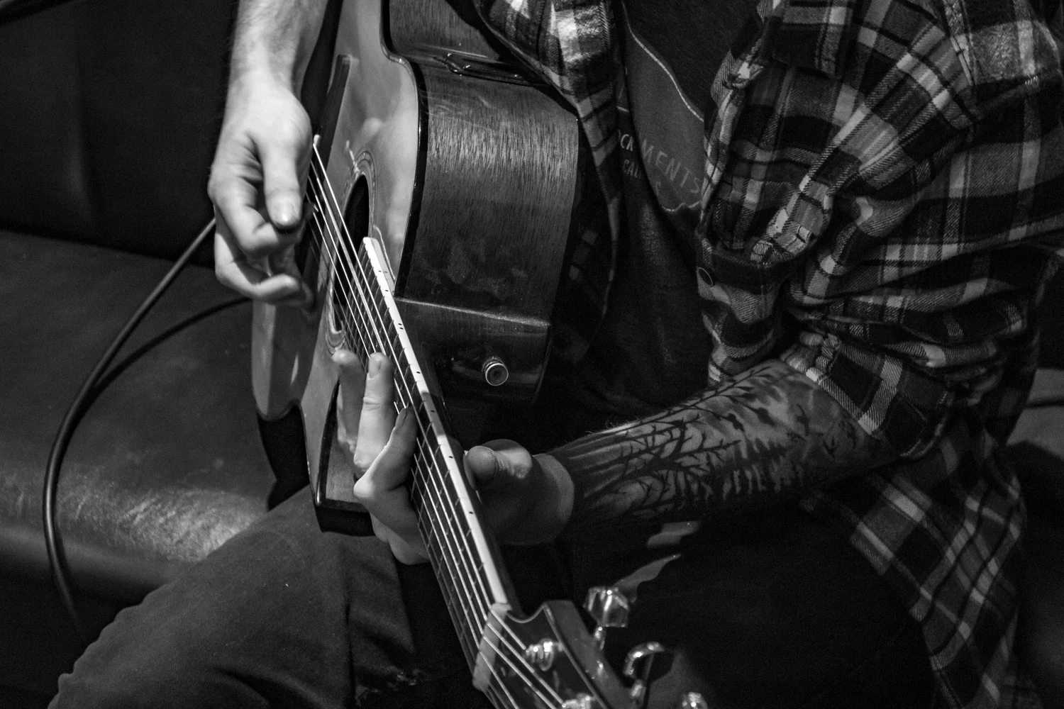 Dan Harry playing acoustic guitar